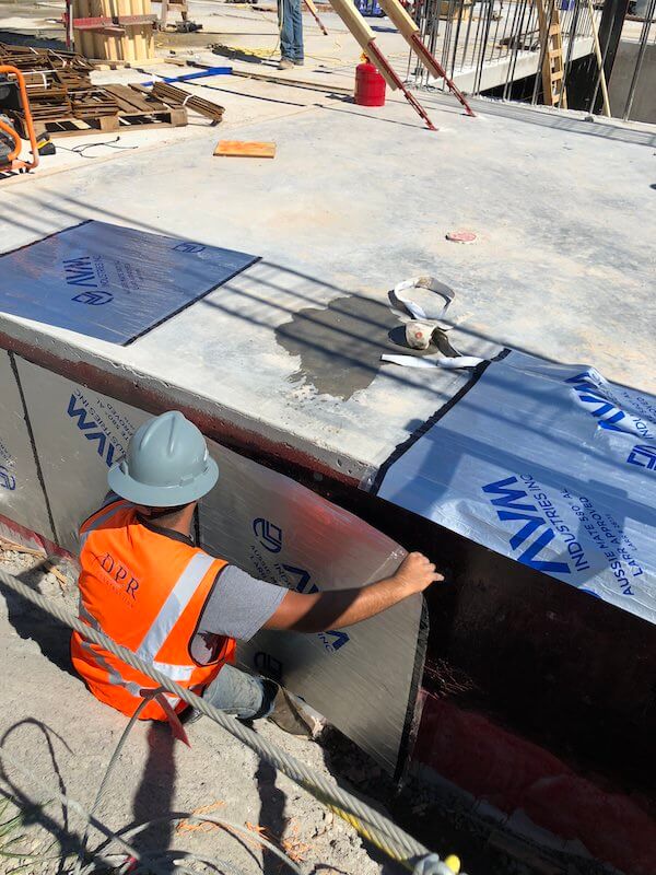 Rolls of Aussie Mate 580-AL Waterproofing being installed