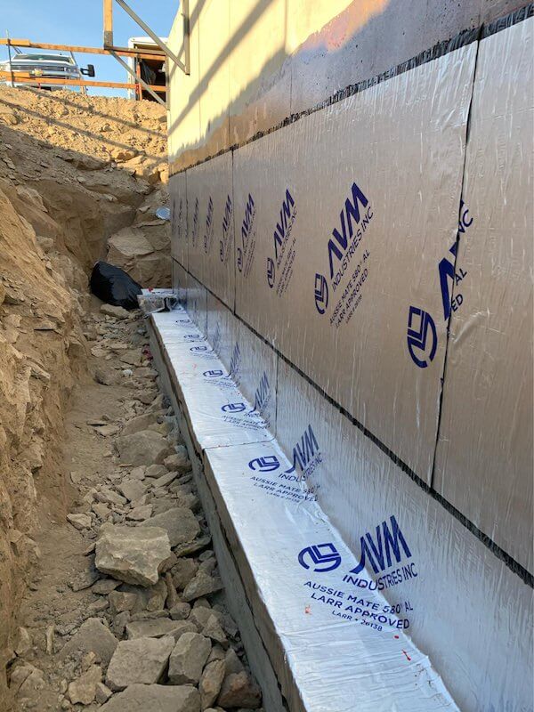 Rolls of Aussie Mate 580-AL Waterproofing being installed