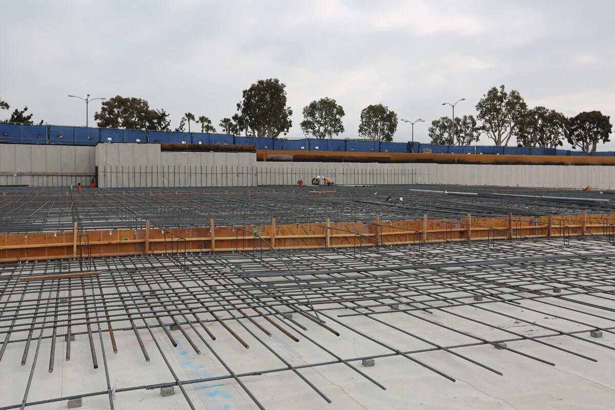 Reinforced concrete slab with rebar grid over prepared waterproofing system