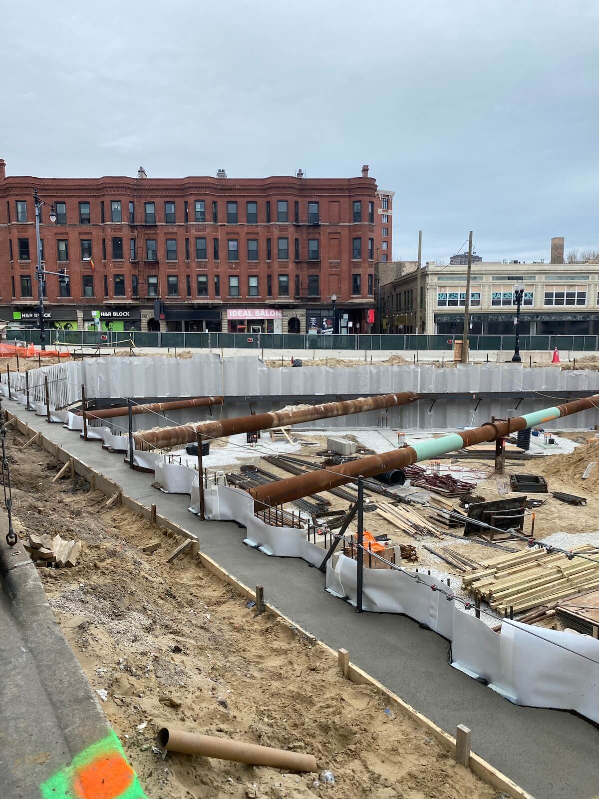 Below-grade foundation waterproofing system installed along excavation perimeter