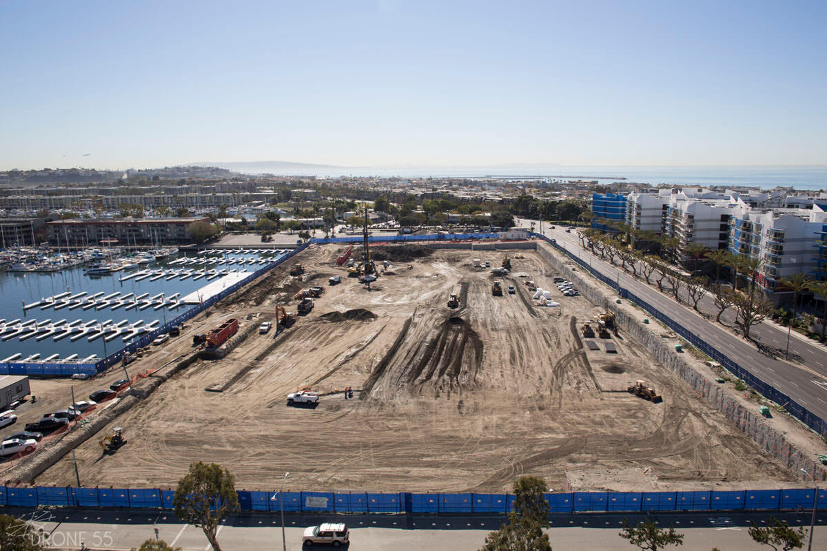 Site preparation for below-grade construction near marina with underslab waterproofing system