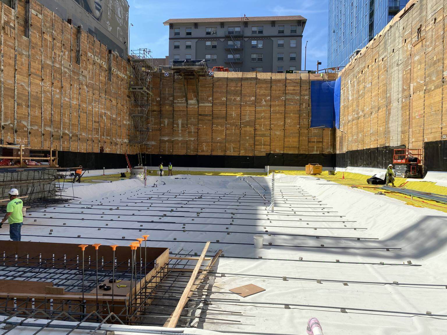Below-grade excavation with waterproofing membrane applied to foundation slab