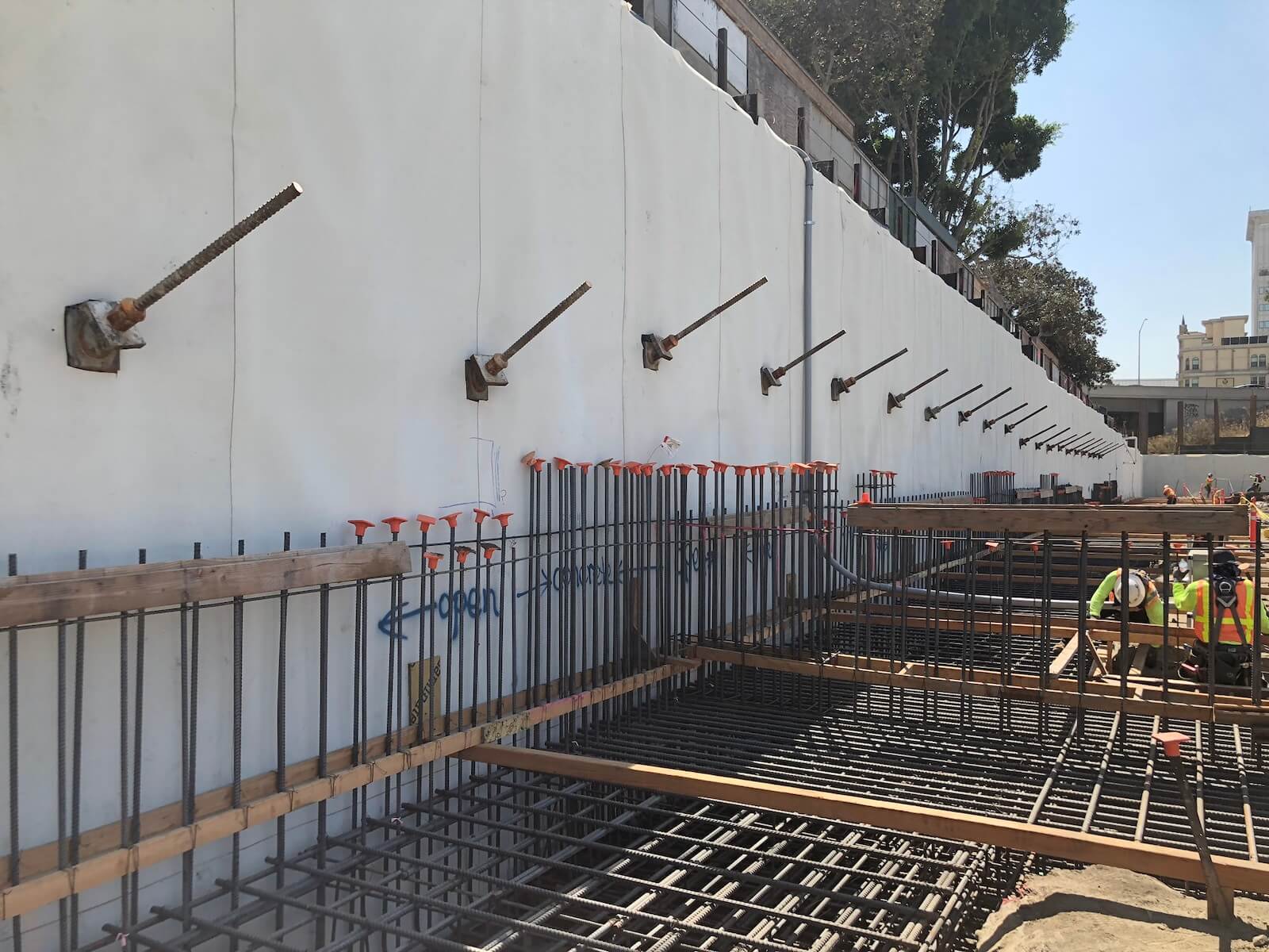 Foundation wall preparation with waterproofing system and rebar installation