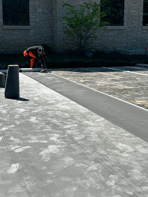 a worker rolling out Aussie Tite